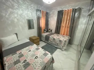 a small bedroom with two beds and a window at 6B Santiago Harmonic Apt Especially For You in Santiago de los Caballeros