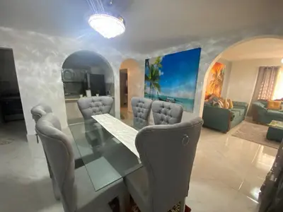 a dining room with a glass table and chairs at 6B Santiago Harmonic Apt Especially For You in Santiago de los Caballeros