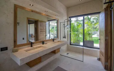 a bathroom with two sinks and a large mirror at Coconut Beach House Playa Bonita Las terrenas Dominican Republic in Las Terrenas