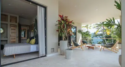 a bedroom with a bed and a patio with plants at Coconut Beach House Playa Bonita Las terrenas Dominican Republic in Las Terrenas