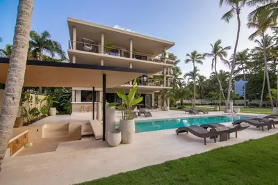 a villa with a swimming pool and a house at Coconut Beach House Playa Bonita Las terrenas Dominican Republic in Las Terrenas