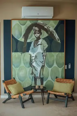 two chairs in front of a wall with a mural at Coconut Beach House Playa Bonita Las terrenas Dominican Republic in Las Terrenas
