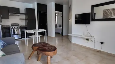 a living room with a couch and a table at Aparta Hotel Monte Vista Sosua in Sosúa