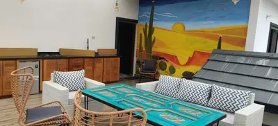 a living room with a table and chairs and a painting at Villa Dario in Nagua