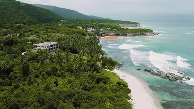 an aerial view of a beach and the ocean at Villa Tesoros del Mar - Luxury Beachfront Villa with Natural Pool, Jacuzzi, Mountain Views, Yoga, BBQ, Wi-Fi, Pet & Family Friendly, Barahona Adventures in El Arroyo