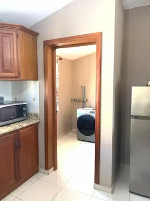 a kitchen with a door open to a kitchen with a microwave at Palm Suites E-6-two-level apartment with a view of the pool in Punta Cana