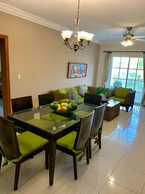 a dining room with a table with fruit on it at Palm Suites E-6-two-level apartment with a view of the pool in Punta Cana