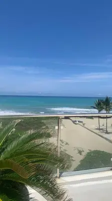 a view of a beach with palm trees and the ocean at B3 beautiful ocean view penthouse - Ocean Front in Cabarete