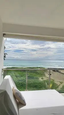 a room with a view of the ocean from a window at B3 beautiful ocean view penthouse - Ocean Front in Cabarete