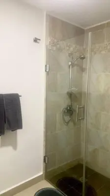 a shower with a glass door in a bathroom at B3 beautiful ocean view penthouse - Ocean Front in Cabarete