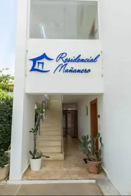 a building with a staircase and a sign on it at B3 beautiful ocean view penthouse - Ocean Front in Cabarete