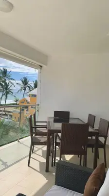 a patio with a table and chairs on a balcony at B3 beautiful ocean view penthouse - Ocean Front in Cabarete