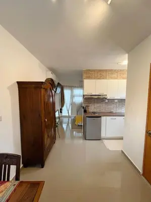a large kitchen with a table and a counter top at Cozy Apartment in Las Galeras in Las Galeras