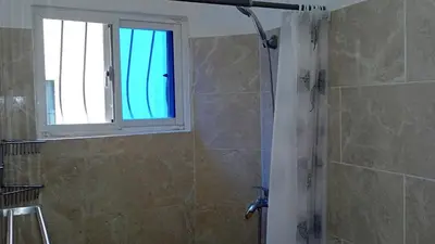 a bathroom with a shower with a window at apart Jacaranda Bayahibe in Bayahibe