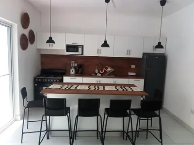 a kitchen with a table and chairs in it at Ocean Bliss in Sosúa