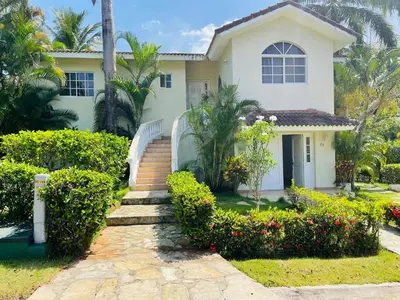 a white house with a staircase in front of it at Luxurious Villa in Sosúa + Pool in Sosúa
