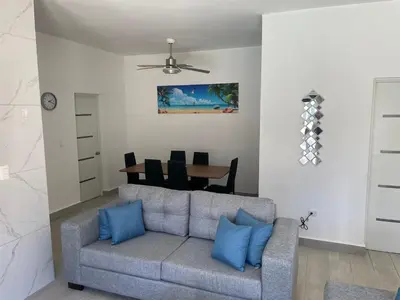a living room with a couch and a table at Level suites VIP in Sosúa