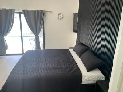 a bedroom with a bed and a clock on the wall at Level suites VIP in Sosúa
