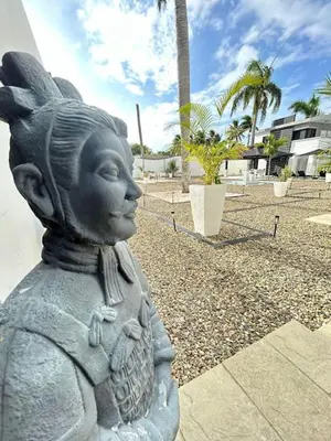 a statue of a little angel sitting on a sidewalk at Level suites VIP in Sosúa