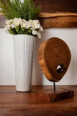 a vase with flowers in it next to a table at Villa de Estilo Japones in Jarabacoa