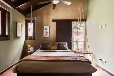 a large bed in a room with a ceiling fan at Villa de Estilo Japones in Jarabacoa