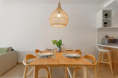 a dining room with a wooden table and chairs at Beautiful apartment with direct access to the pool in Punta Cana
