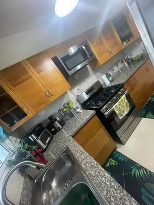 an overhead view of a kitchen with a sink and a stove at Apartamento completo con jacuzzi y gazebo in Santo Domingo