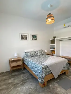 a bedroom with a bed and two night stands at Villa Mar En Dreams House - 4 Pax, 2 Min de La Playa in Las Galeras