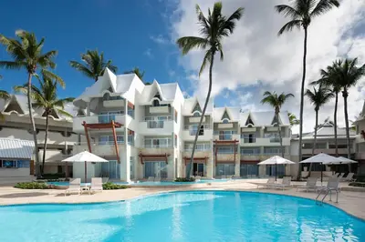 a hotel with a swimming pool in front of a building at Select Sosua Adults Only, Trademark by Wyndham All Inclusive in Sosúa