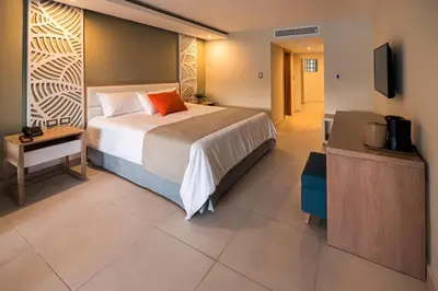 a hotel room with a bed and a television at Select Sosua Adults Only, Trademark by Wyndham All Inclusive in Sosúa