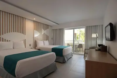 a hotel room with two beds and a balcony at Select Sosua Adults Only, Trademark by Wyndham All Inclusive in Sosúa