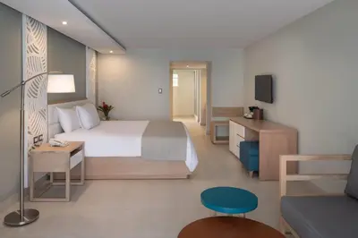 a hotel room with a bed and a couch at Select Sosua Adults Only, Trademark by Wyndham All Inclusive in Sosúa