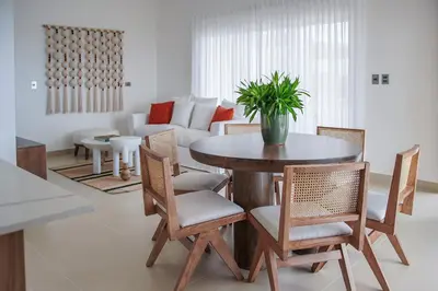 a living room with a table and chairs and a couch at Atlantic Paradise Cabrera in Arroyo Azul