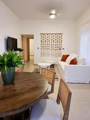 a living room with a table and a couch at Atlantic Paradise Cabrera in Arroyo Azul