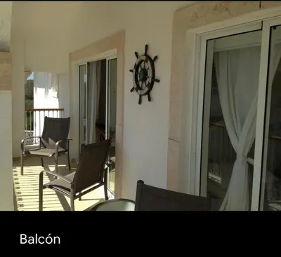 a room with chairs and a clock on the wall at Cadaqués, Bayahibe, República Dominicana in Bayahibe