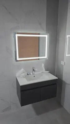 a white bathroom with a sink and a mirror at El Colibri Hotel in Sosúa