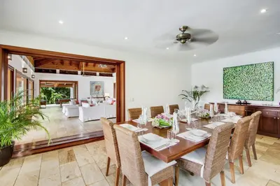 a dining room with a table and chairs at Gorgeous villa at Casa de Campo - with large pool, cook, maid and 2 golf carts in La Romana