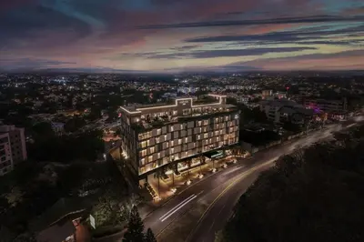 a building on a city street at night at AC Hotel by Marriott Santiago de los Caballeros in Santiago de los Caballeros