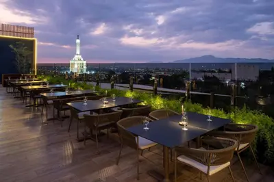 a row of tables on the roof of a building at AC Hotel by Marriott Santiago de los Caballeros in Santiago de los Caballeros