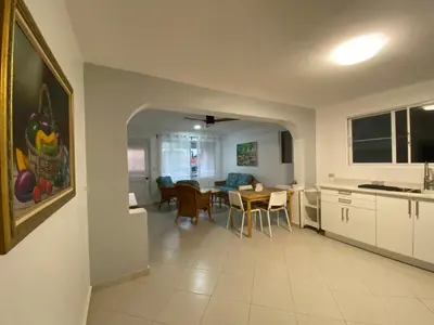 a kitchen and living room with a table and chairs at 1BR Suite at Villa Costa Verde near Playa Cofresi, Puerto Plata, with a pool, balcony and a rooftop terrace in San Felipe de Puerto Plata
