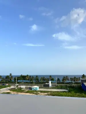 a view of a street with the ocean in the background at Posada del caribe in La Cana
