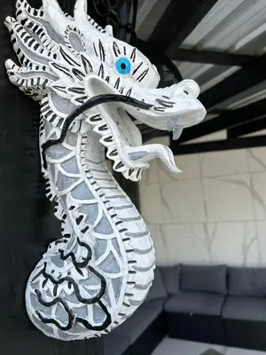 a white statue of a dragon on a wall at LEVEL suites #7 in Sosúa