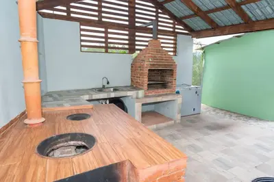 an outdoor kitchen with a brick oven and a table at The American Dream in Jarabacoa