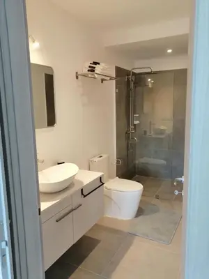 a bathroom with a toilet and a sink and a shower at Sabrina Plaza Residence in Las Terrenas