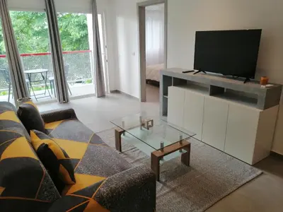 a living room with a couch and a flat screen tv at Sabrina Plaza Residence in Las Terrenas