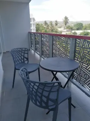 two tables and chairs on a balcony with a view at Sabrina Plaza Residence in Las Terrenas