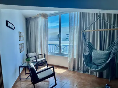 a living room with a hammock and a balcony at Apartamento ll Vista al Mar Albatros BY JU Juan Dolio in Juan Dolio