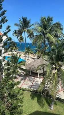 an aerial view of a resort with palm trees and the ocean at Apartamento ll Vista al Mar Albatros BY JU Juan Dolio in Juan Dolio