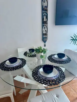 a glass table with four blue dishes on it at Apartamento ll Vista al Mar Albatros BY JU Juan Dolio in Juan Dolio