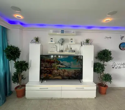a flat screen tv in a living room at Beachfront Apartment with Jacuzzi in Juan Pedro